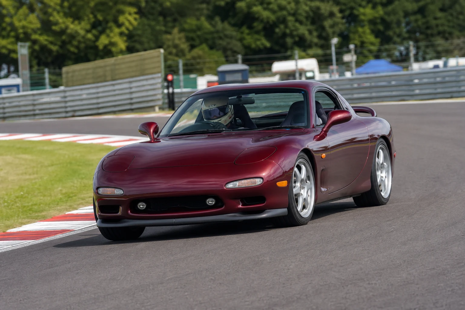 Mazda RX7 FD on track with a helmeted driver