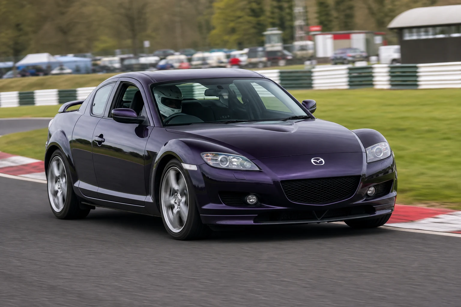 Mazda RX8 on track with a helmeted driver
