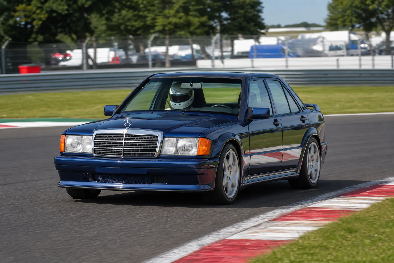 Mercedes Benz 190E on track with a helmeted driver