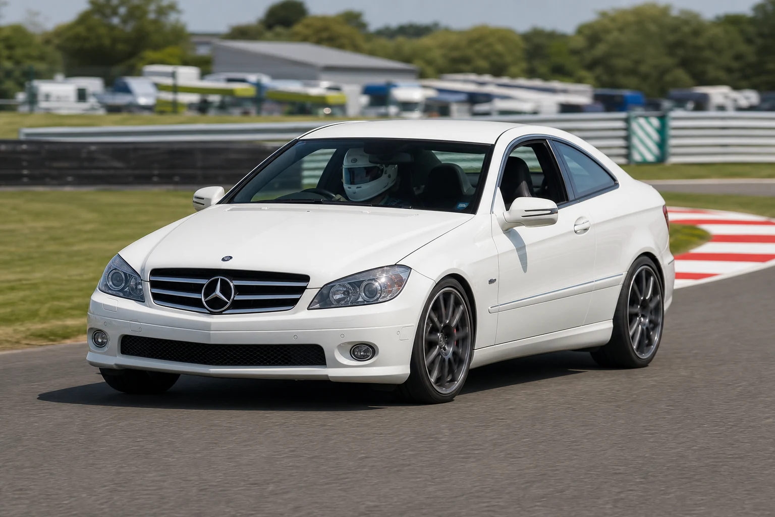 Mercedes C-Class Coupe on track with a helmeted driver