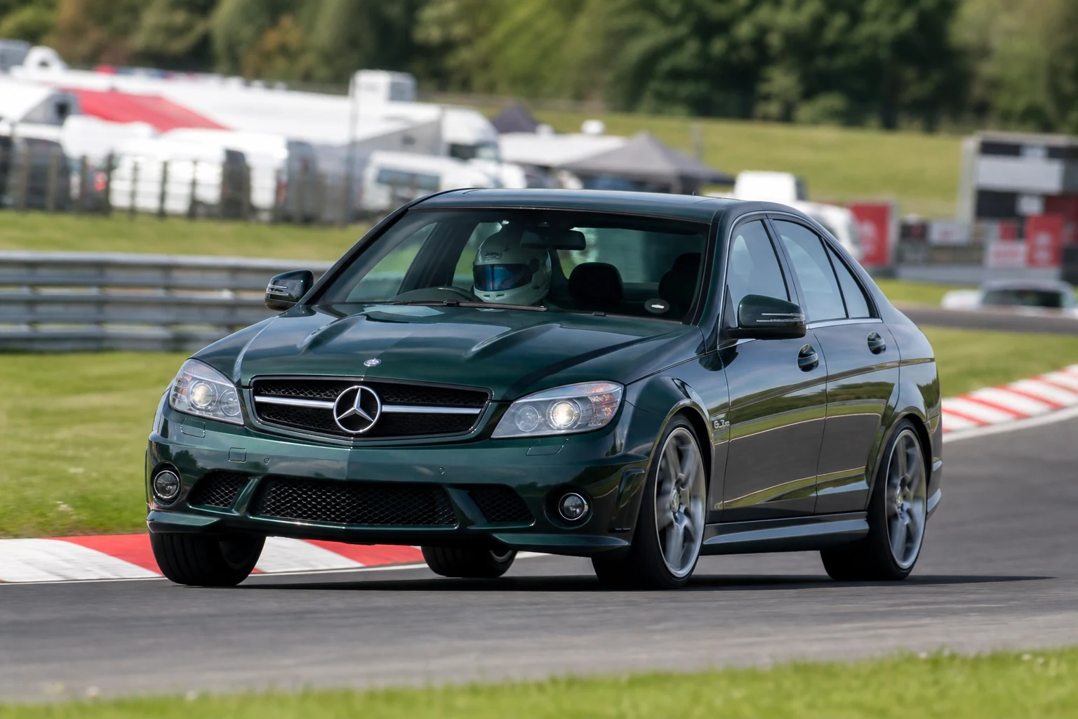 Mercedes C63 AMG on track with a helmeted driver