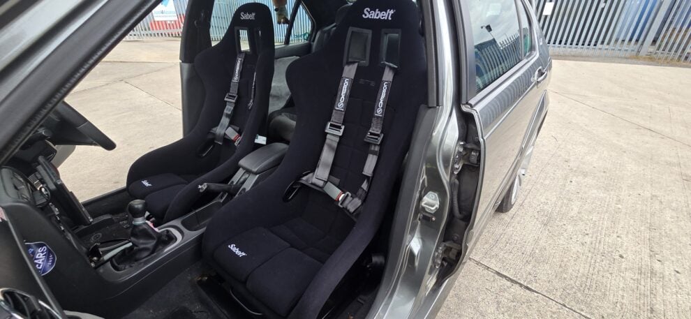 Sabelt GT3 bucket seats and Corbeau harnesses in a grey MG ZS seen through the open passenger door
