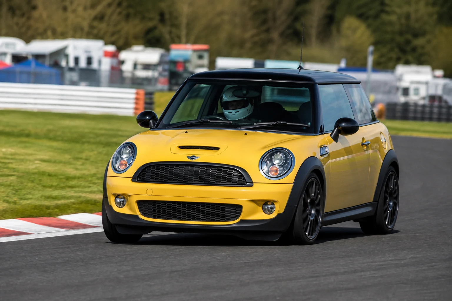 Mini R53-56 on track with a helmeted driver
