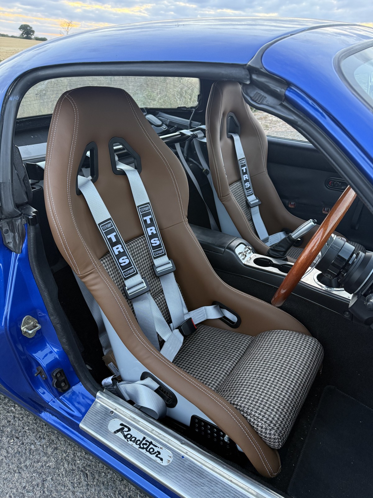 Pair of Mirco houndstooth bucket seats with silver TRS four point harnesses in a Mk1 MX-5