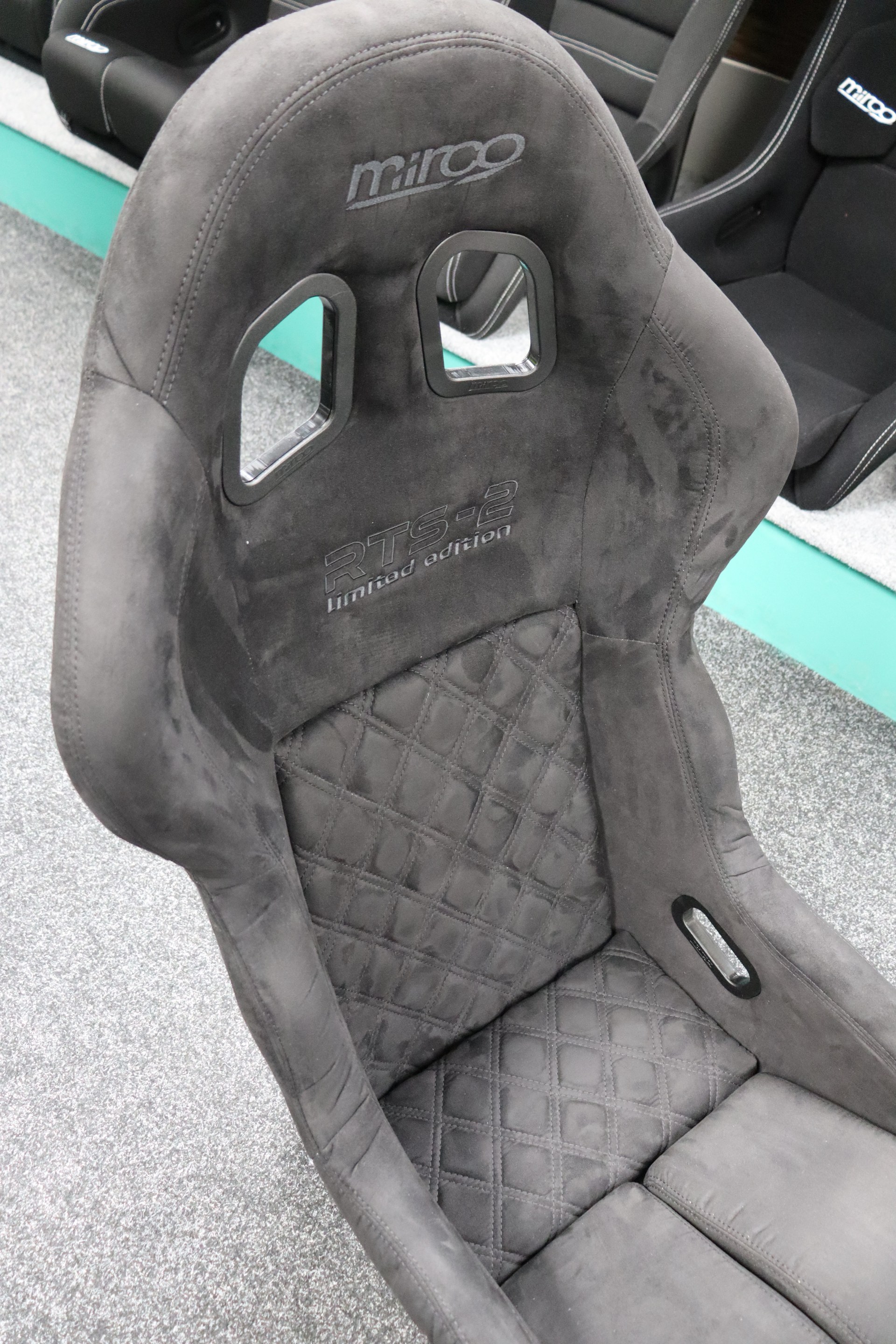 Full front view of the Mirco RTS-2 Stealth Edition bucket seat showing the harness slots and Mirco branding