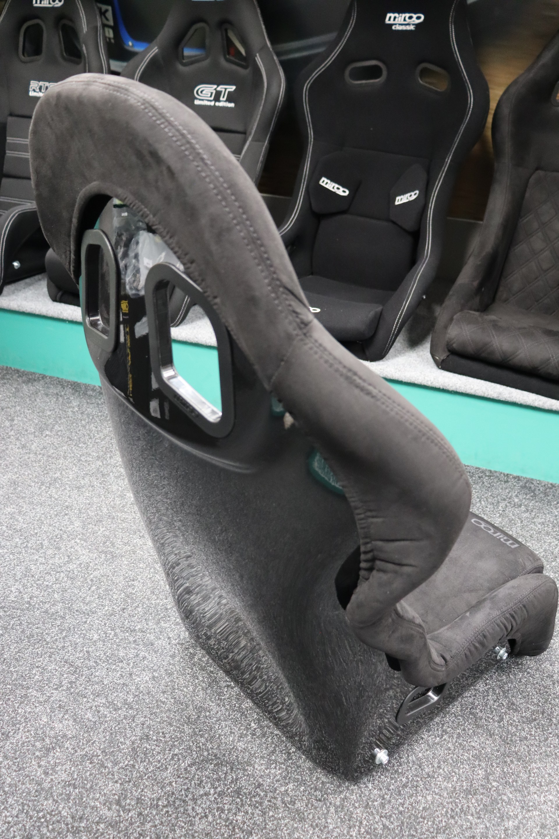 Gloss black fibreglass shell back of the Mirco RTS-2 Stealth Edition with two harness slot cutouts