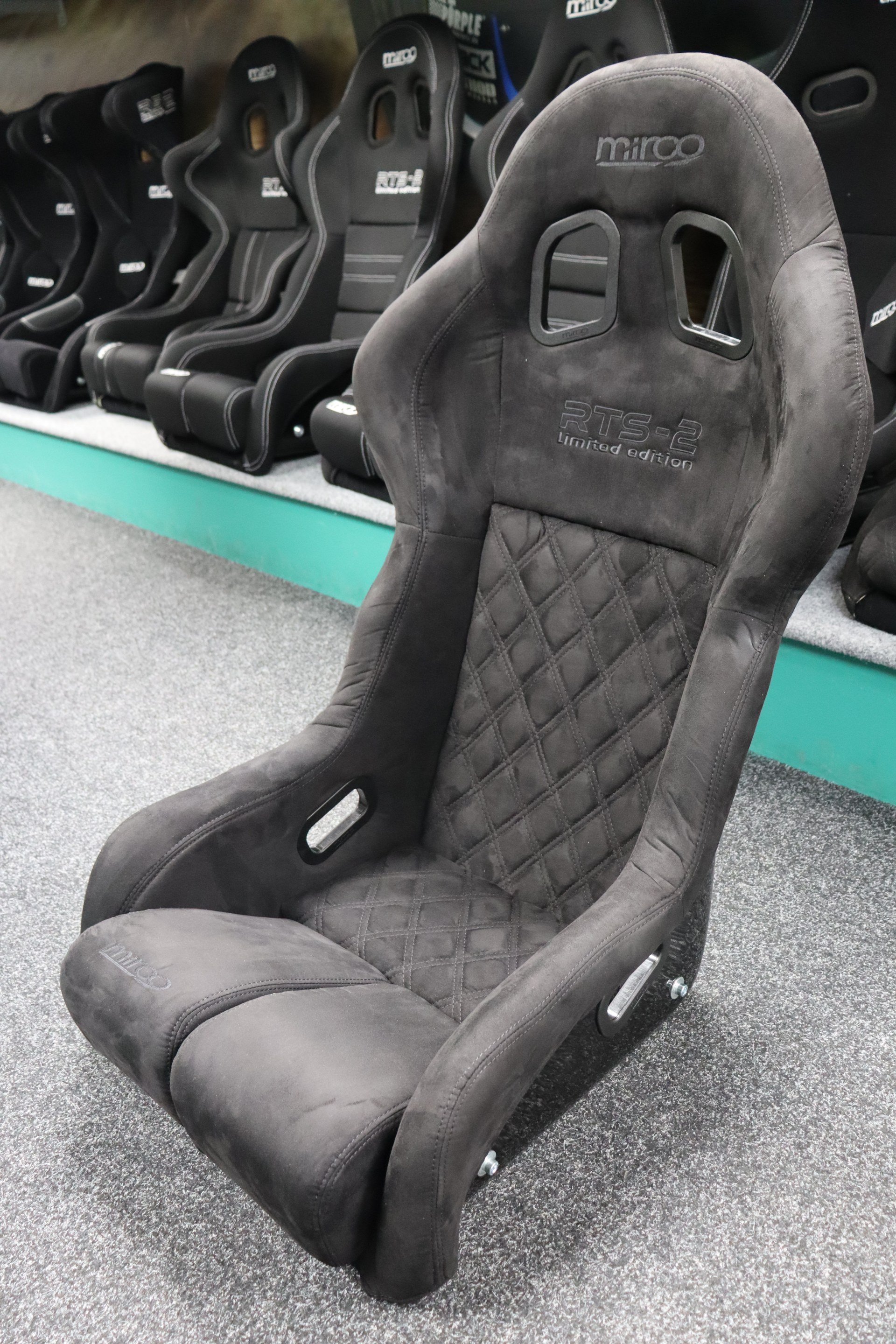 Three-quarter front view of the Mirco RTS-2 Stealth Edition bucket seat showing the diamond quilted centre panel