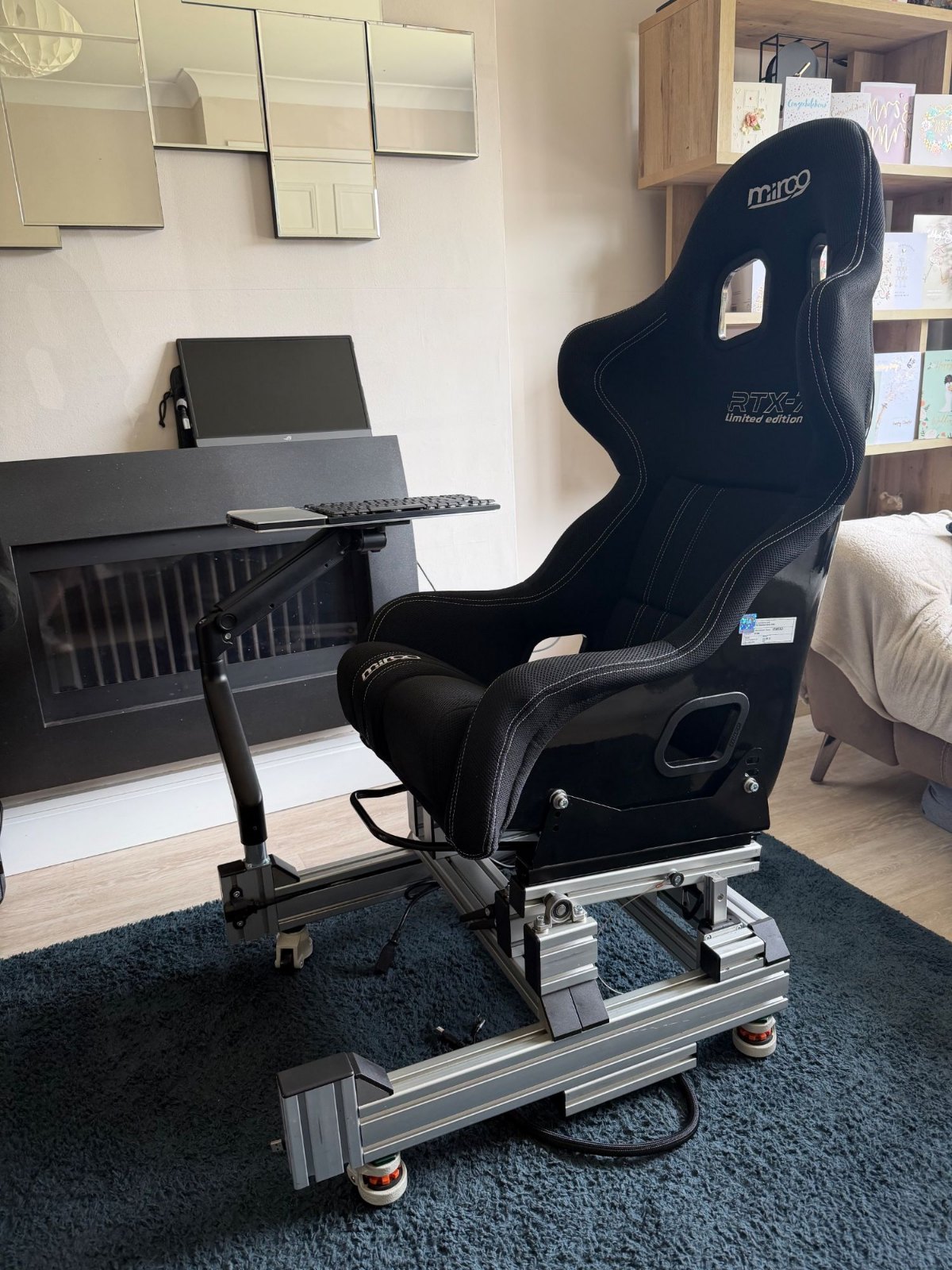 Mirco RTX-7 Limited Edition FIA bucket seat in black 3D mesh with silver stitching, fitted to a sim rig