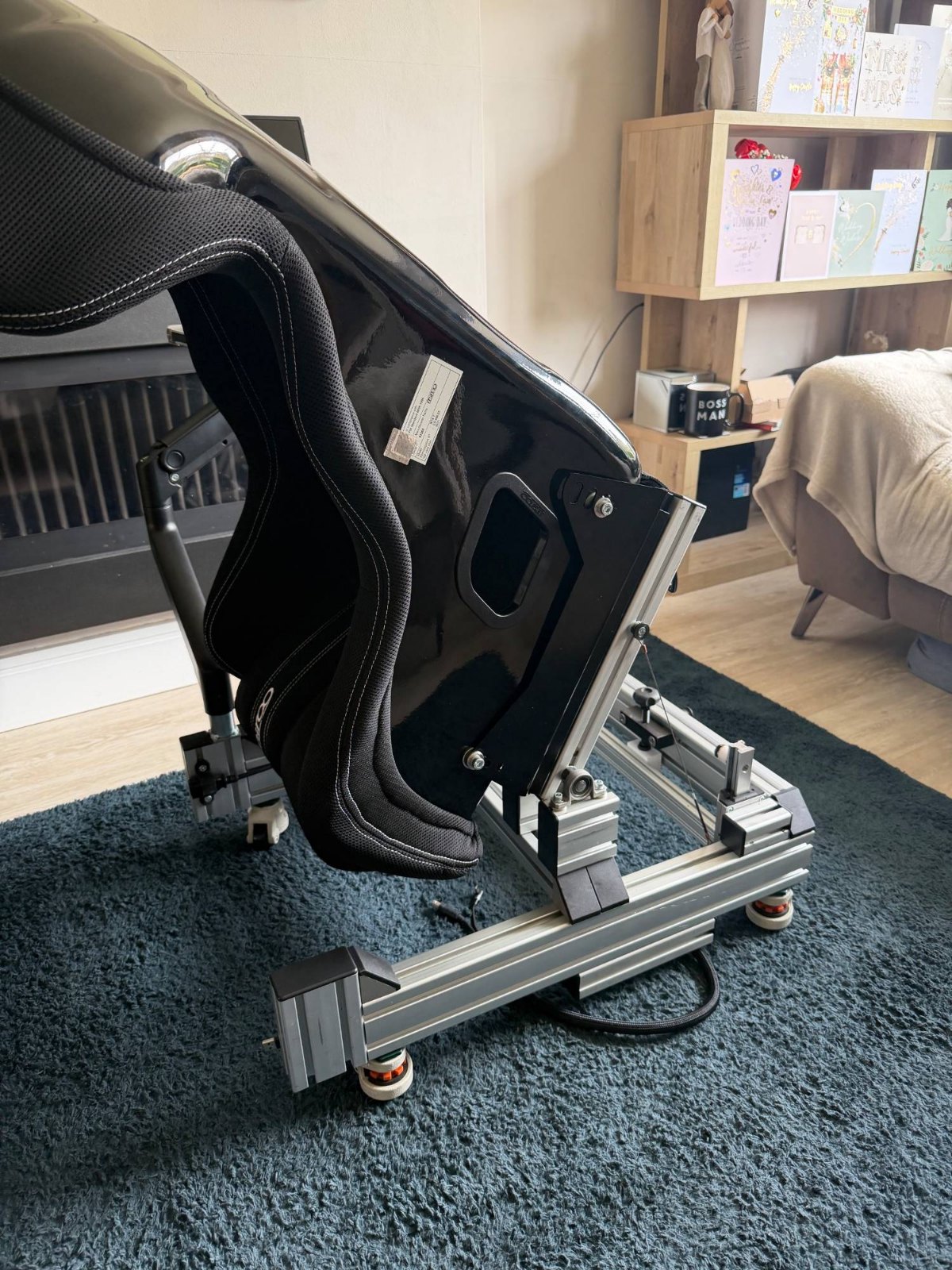 Rear view of a Mirco RTX-7 showing side mount brackets bolted to the aluminium extrusion of a sim rig