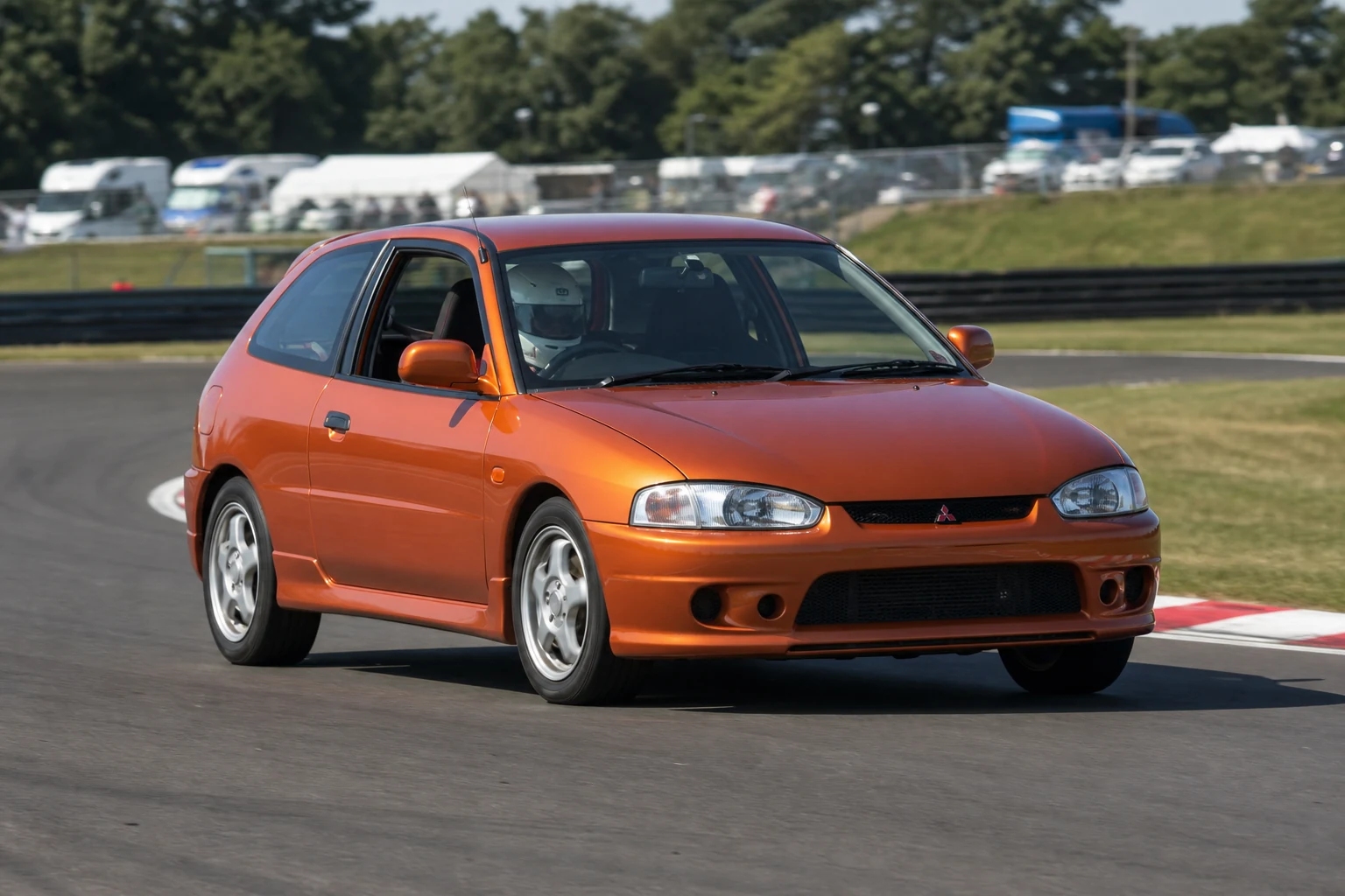 Mitsubishi Colt Z30 on track with a helmeted driver