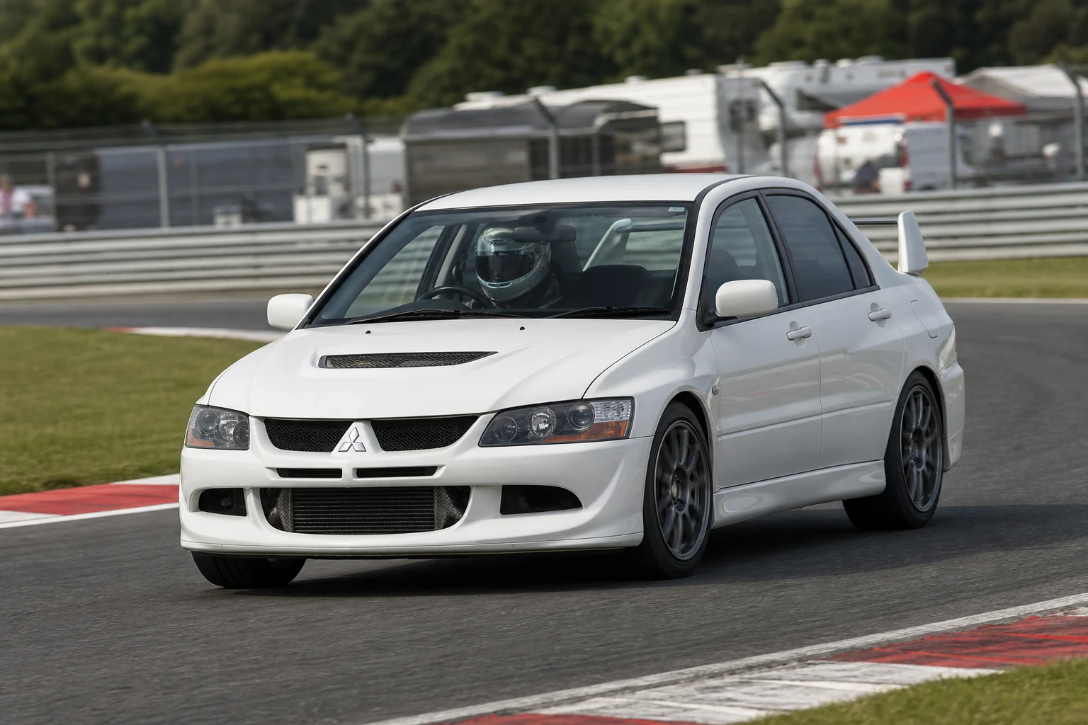 Mitsubishi Evo IX on track with a helmeted driver