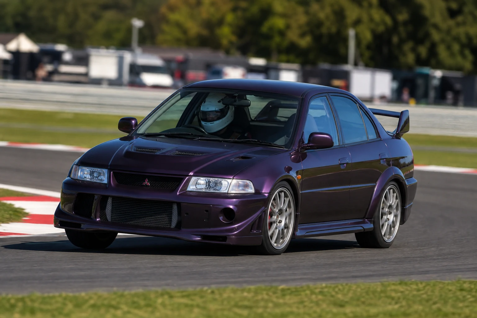 Mitsubishi Evo VI on track with a helmeted driver