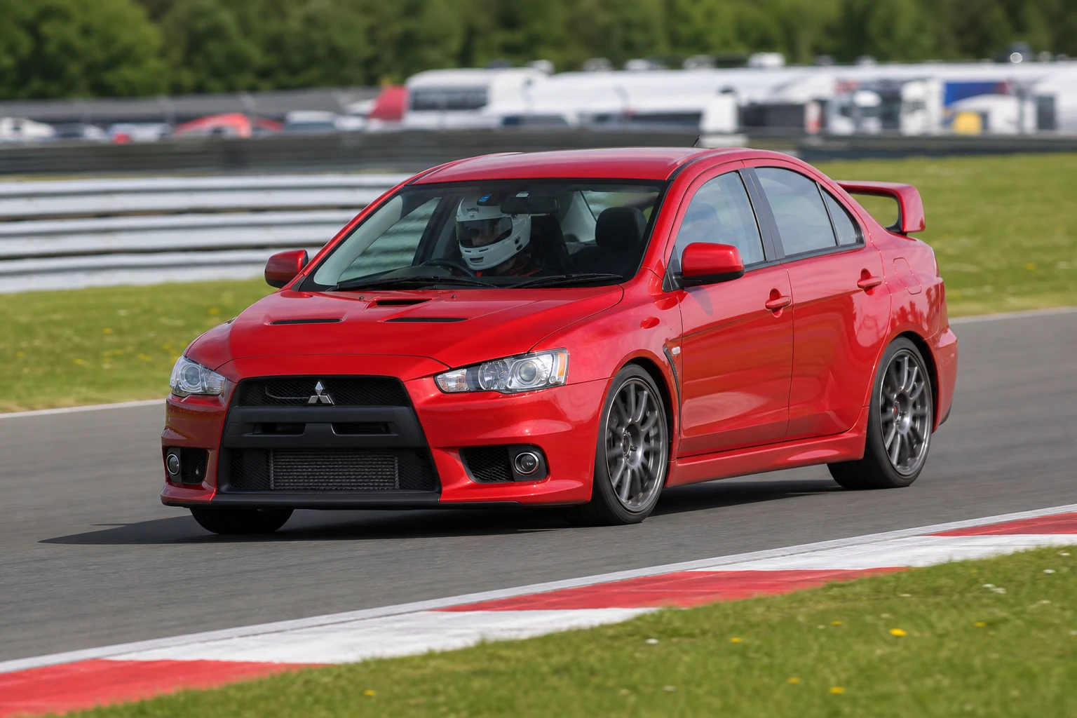 Mitsubishi Evo X on track with a helmeted driver