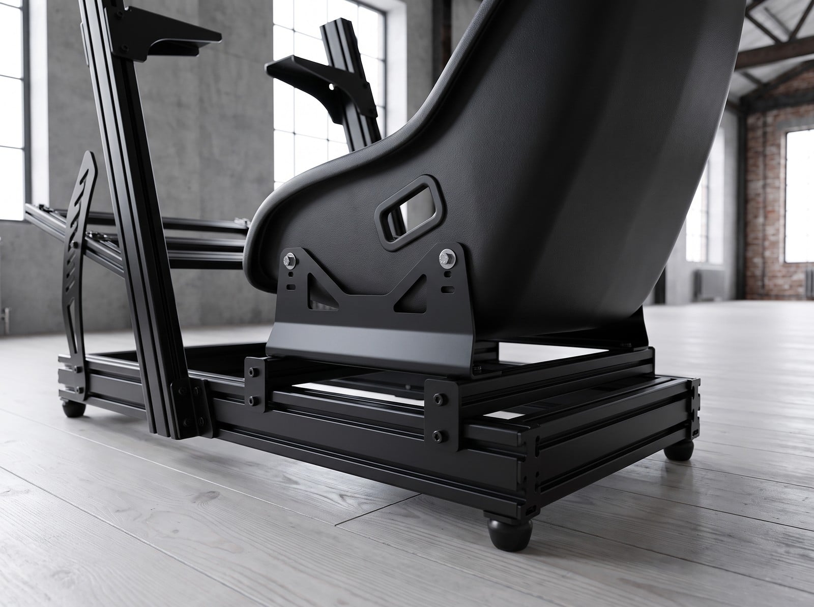 Plain black bucket seat held by tall slotted steel side brackets on the black profile rails of a Next Level Racing style rig