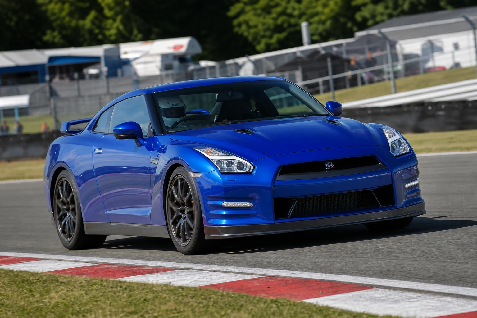 Nissan GTR on track with a helmeted driver