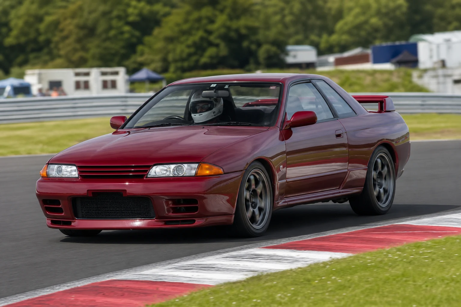 Nissan Skyline R32 on track with a helmeted driver