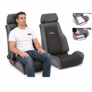 Person seated in Pair of Cobra Le Mans Land Rover Defender Seats (part LMR-V-S-BK-X2) showing real-world seat size and fit – GSM Performance