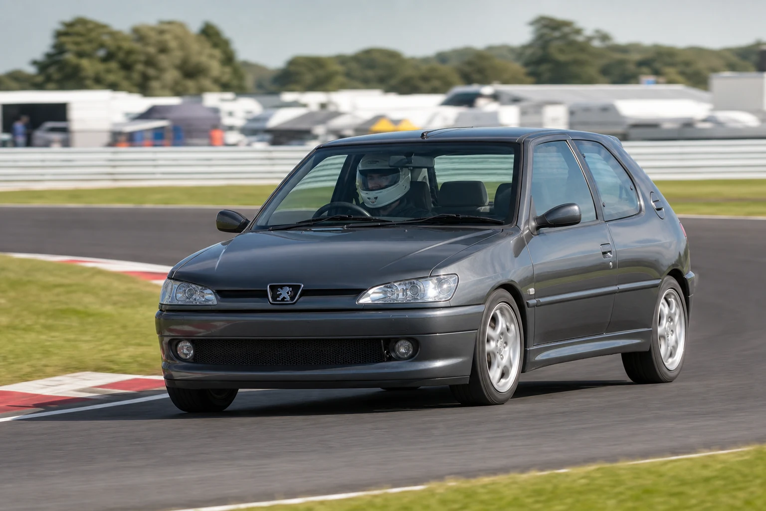 Peugeot 306 on track with a helmeted driver