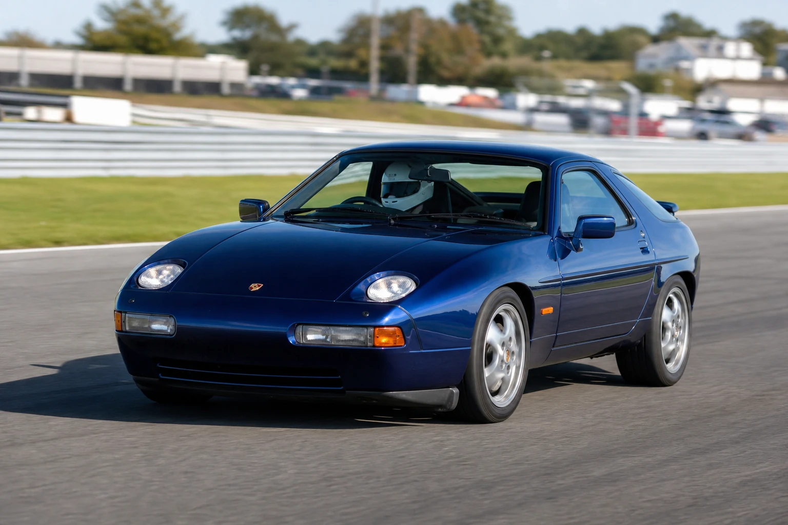 Porsche 928 on track with a helmeted driver