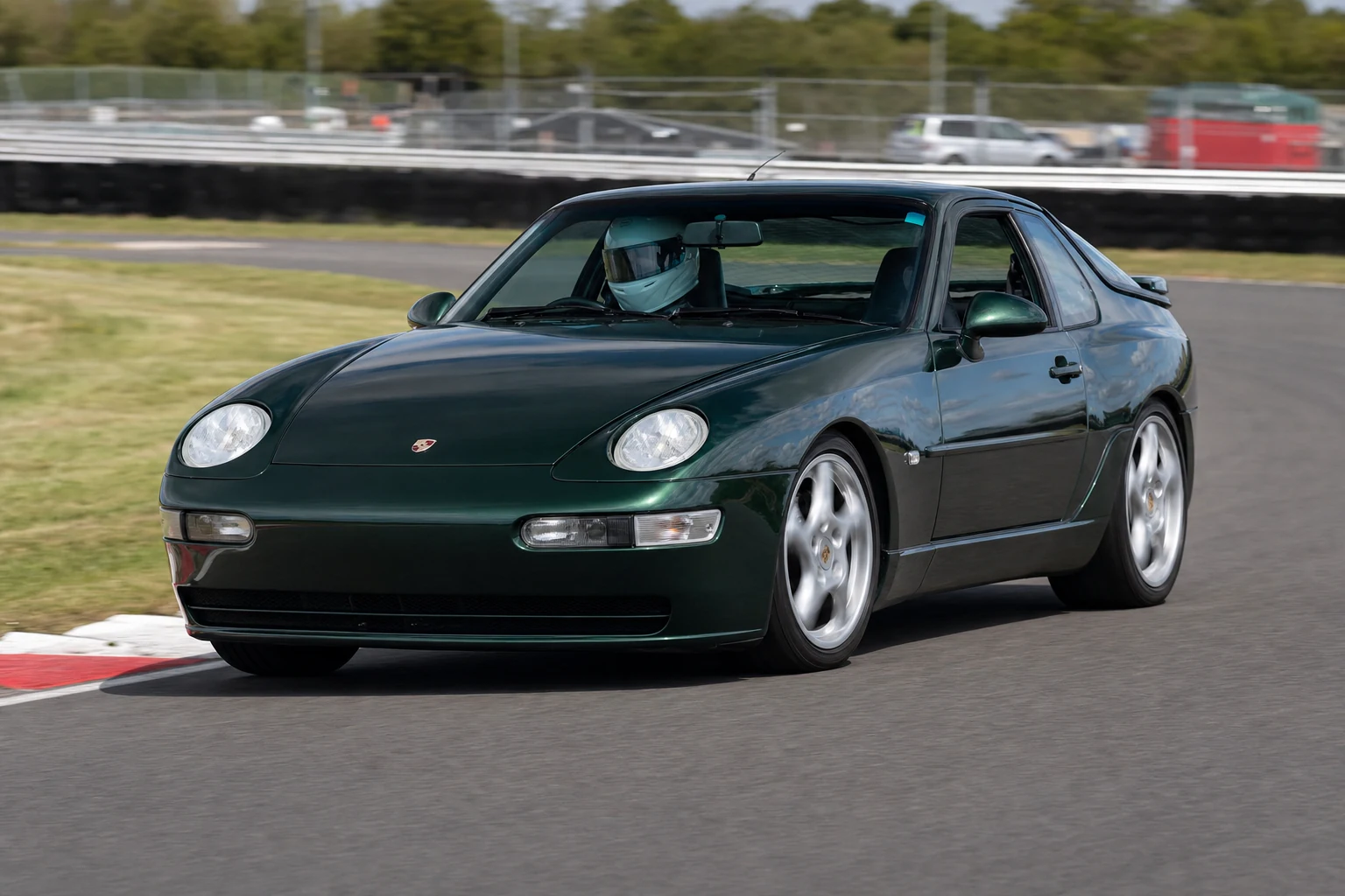 Porsche 968 on track with a helmeted driver