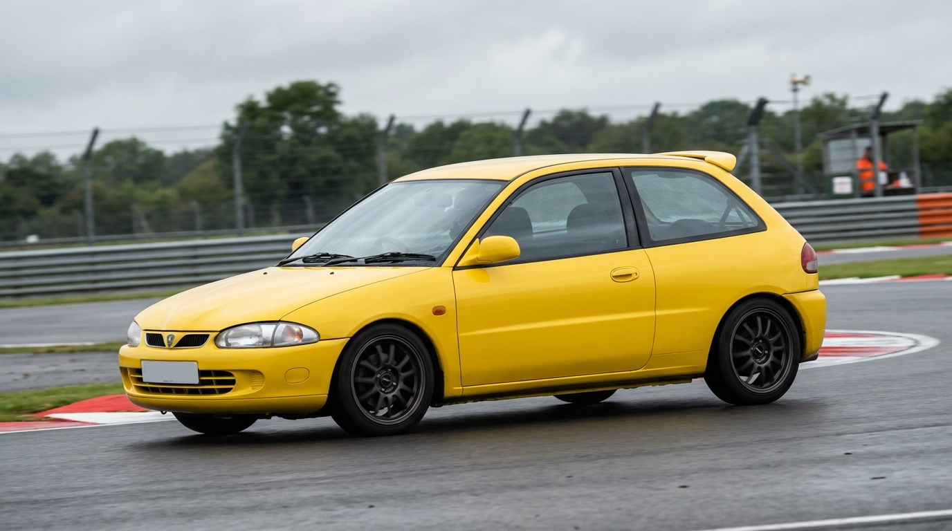 A yellow Proton Satria three door hatchback on a British race circuit at an apex