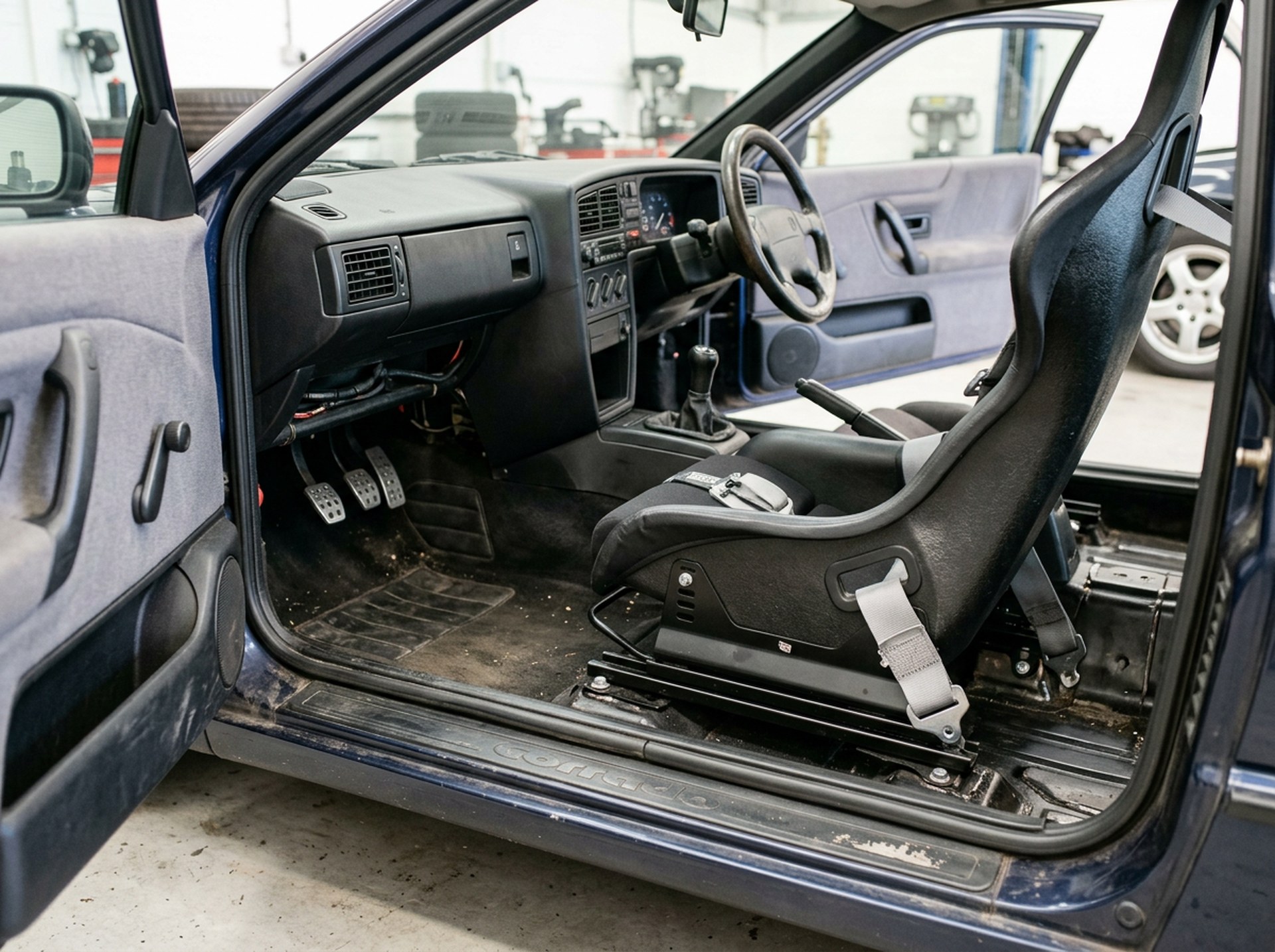 Fixed back bucket seat mounted on steel side mounts and a floor subframe in a right-hand drive VW Corrado