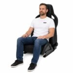 Person seated in Recaro Sportster CS Reclining Sport Seat With Heating And SAB (part 411.10) showing real-world seat size and fit – GSM Performance