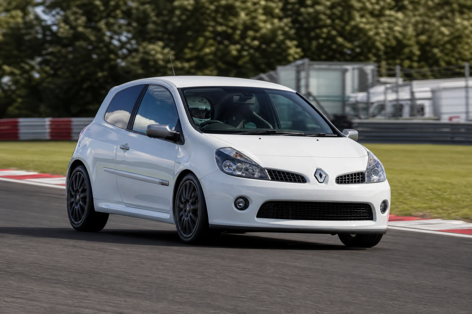 Renault Clio Mk3 RS200 on track with a helmeted driver