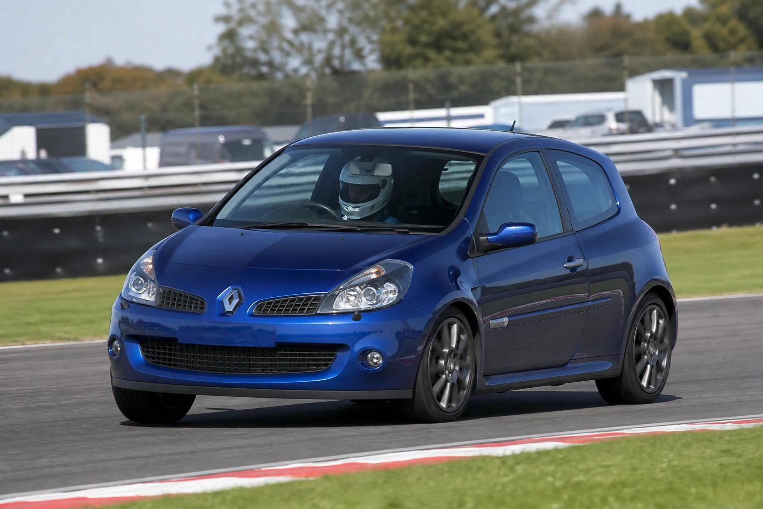 Renault Clio MK3 on track with a helmeted driver