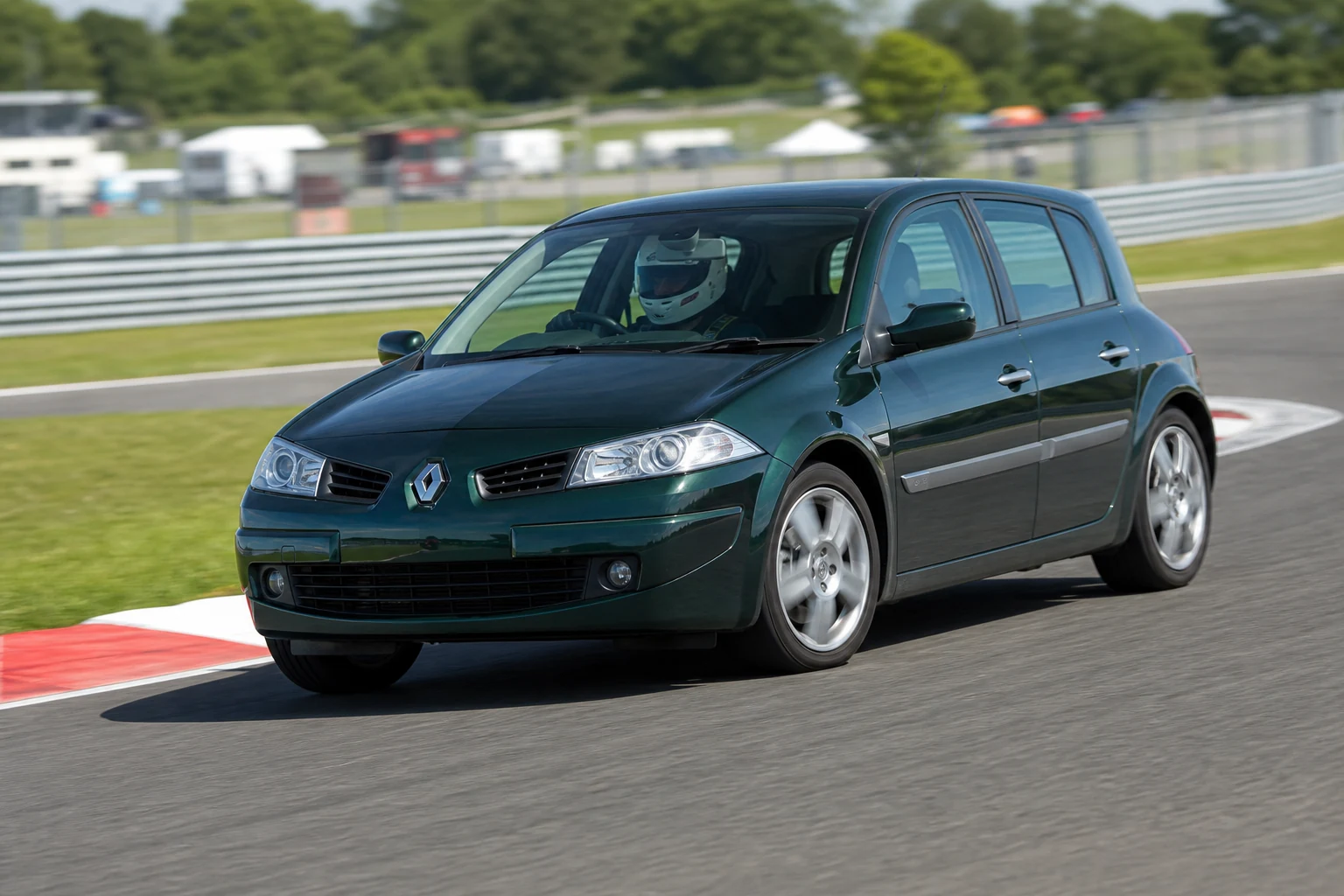 Renault Megane 2 on track with a helmeted driver