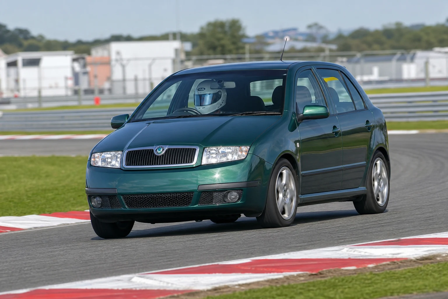 Skoda Fabia MK1 6Y on track with a helmeted driver
