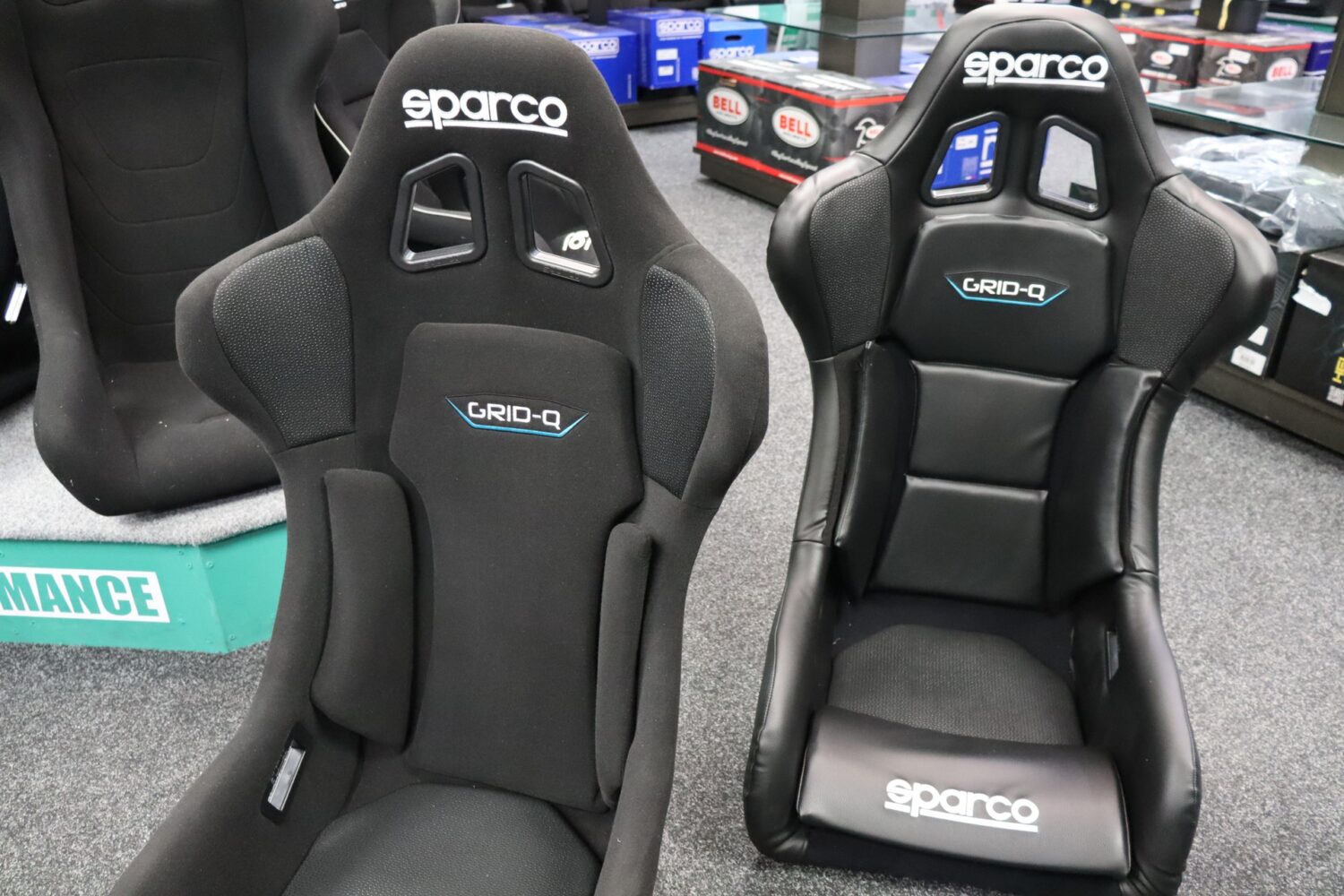 Sparco Grid Q in fabric trim next to the Grid Q Sky in vinyl trim on the SportSeats4u showroom floor
