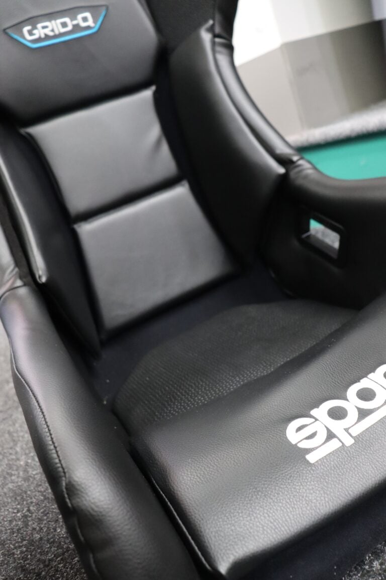 Close view of the Sparco Grid Q Sky showing the vinyl panels and the fabric centre of the cushion