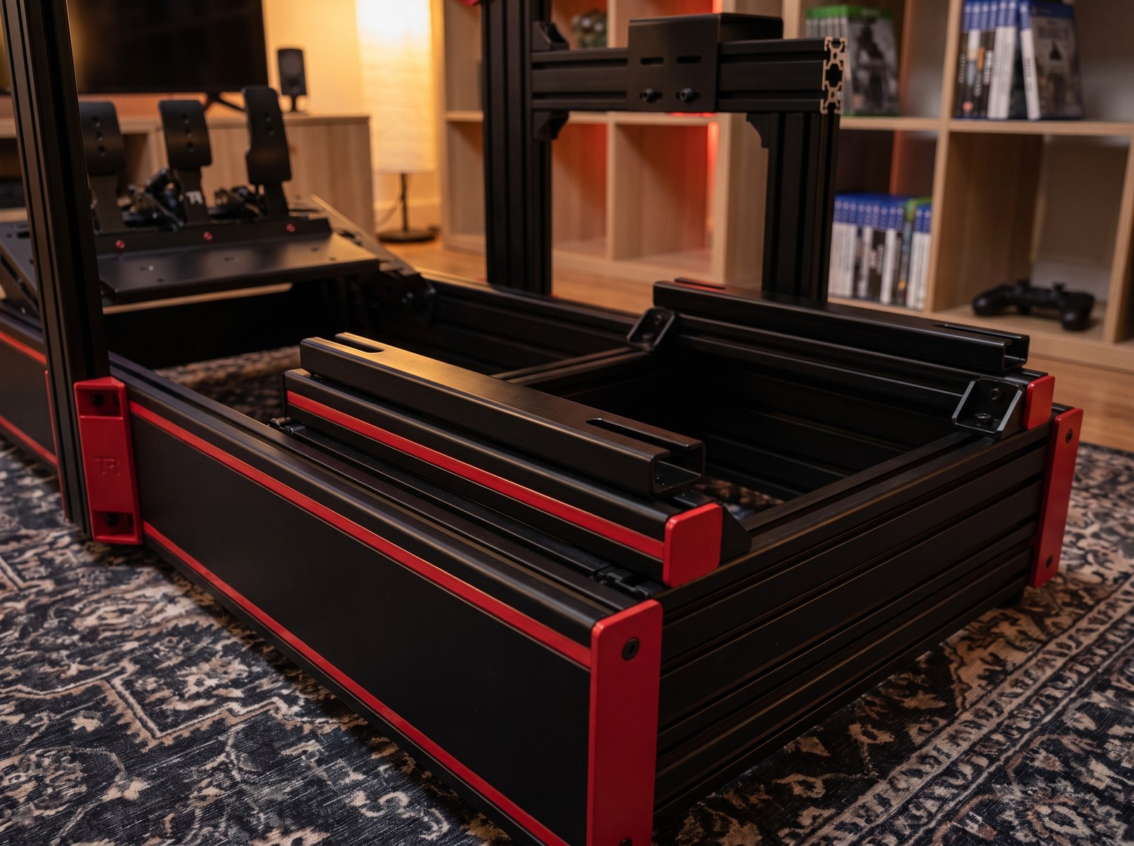Seat sliding runner tracks laid across the seat rails of a Trak Racer style rig with red striped skirt panels, no seat fitted