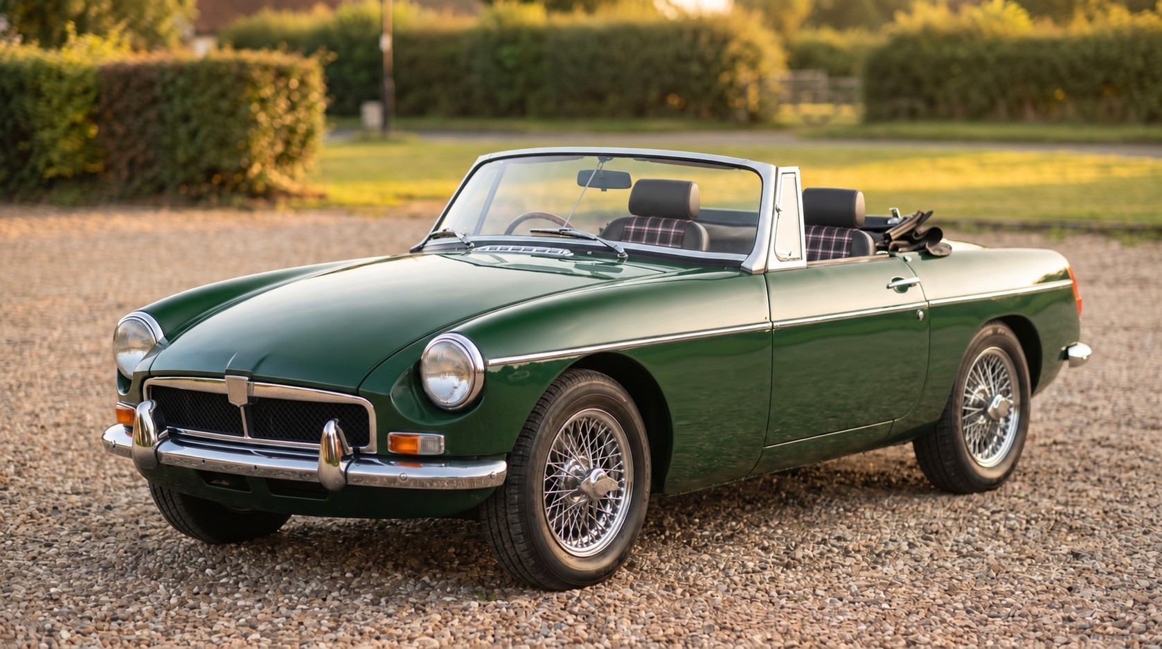 British racing green classic roadster fitted with black Cobra seats with red, white and grey tartan centre trim