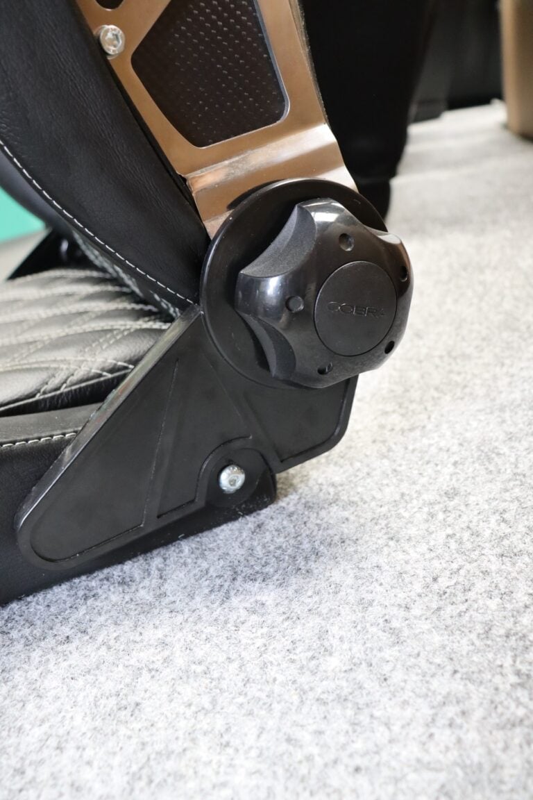 Close up of the Cobra branded round hand wheel on the side of a Cobra Misano Anniversary reclining sports seat