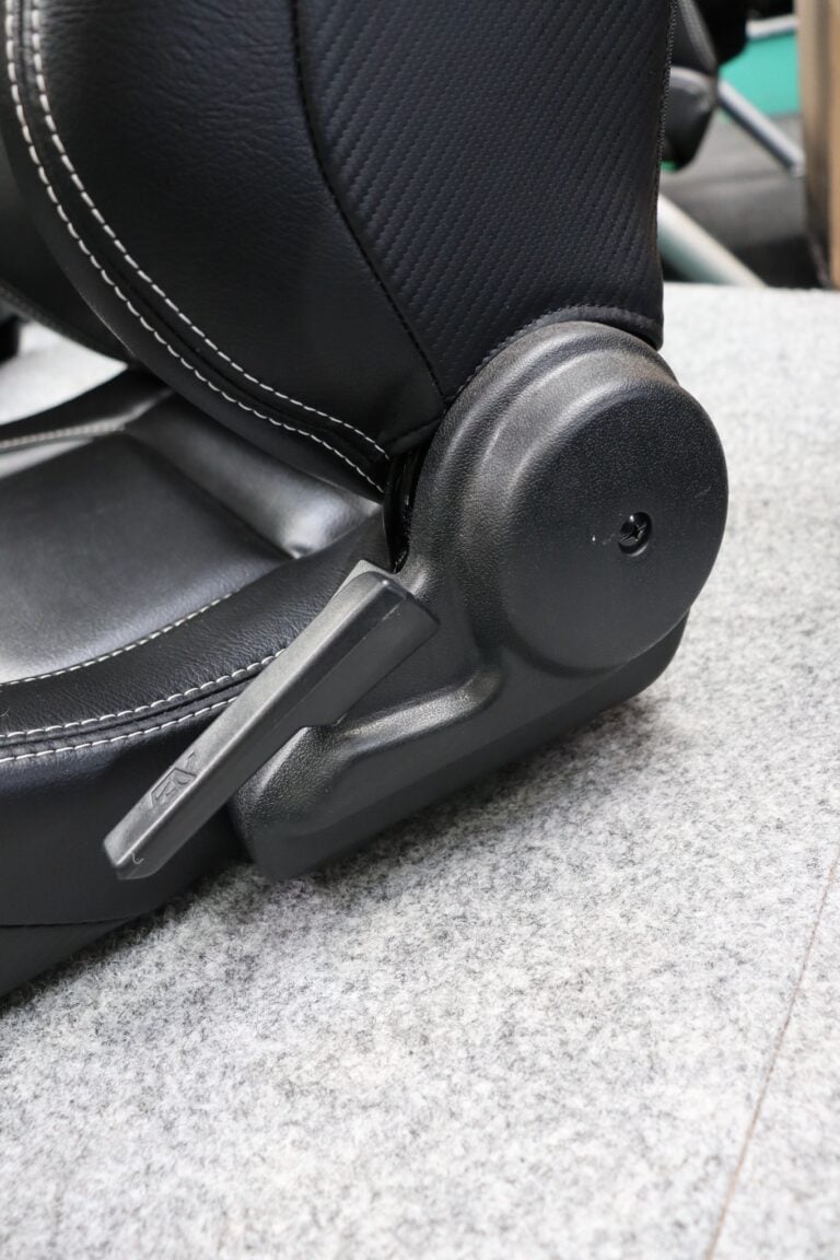 Close up of the long quick tilt lever on the side of a Corbeau Sportline RRS reclining sports seat in black leather