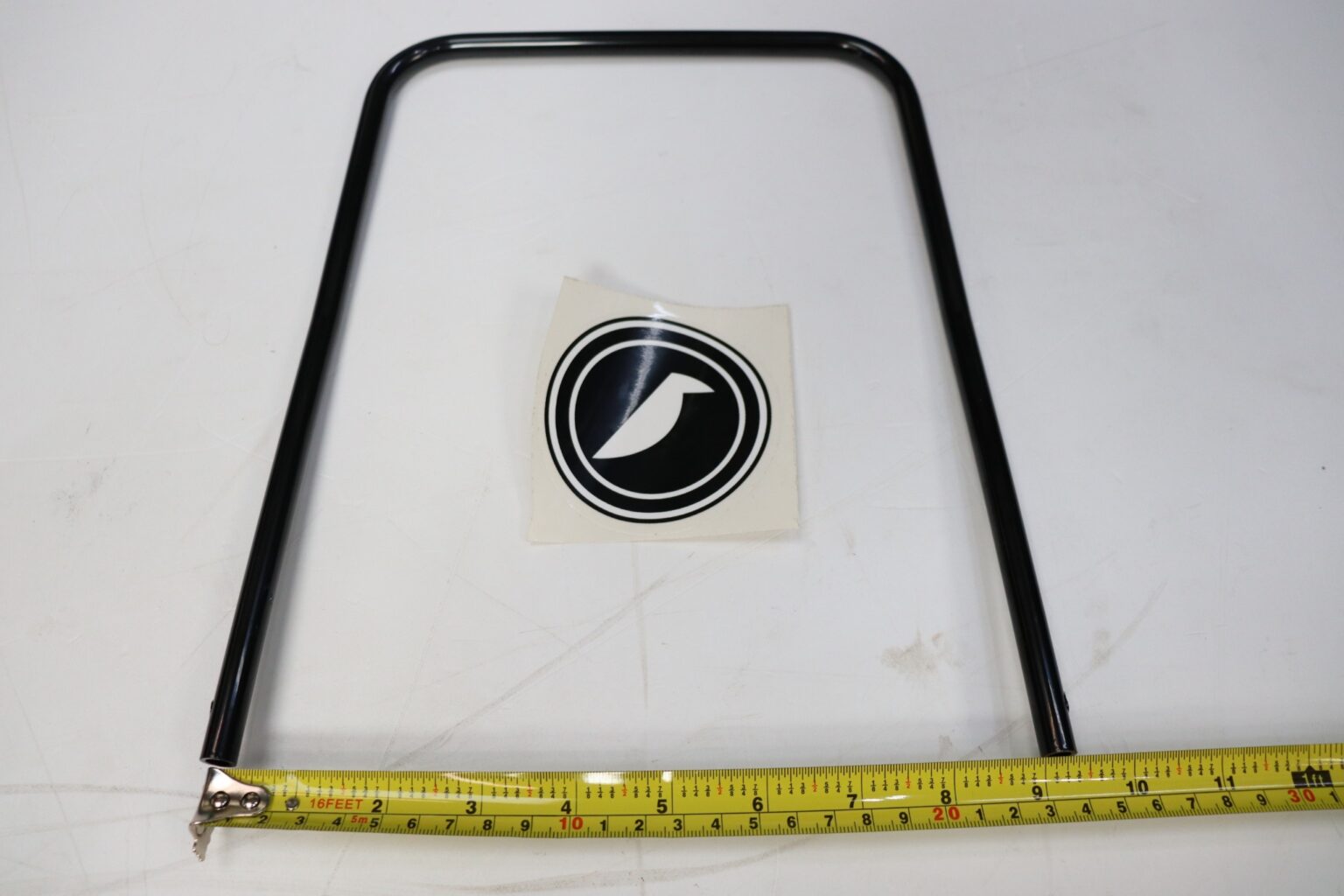 Corbeau seat runner release handle laid flat with a tape measure running beneath it