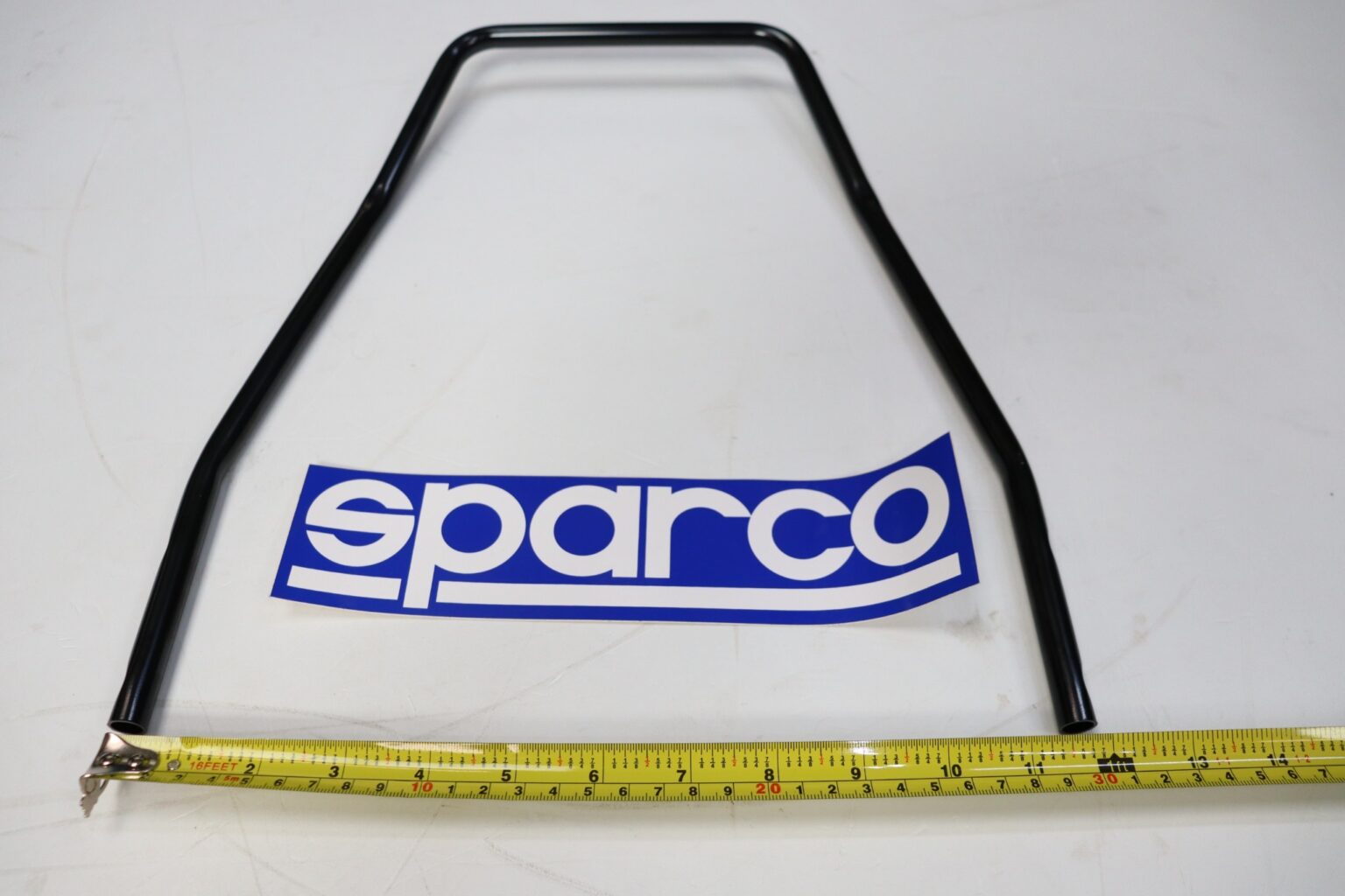 Sparco seat runner release handle laid flat with a tape measure beneath it