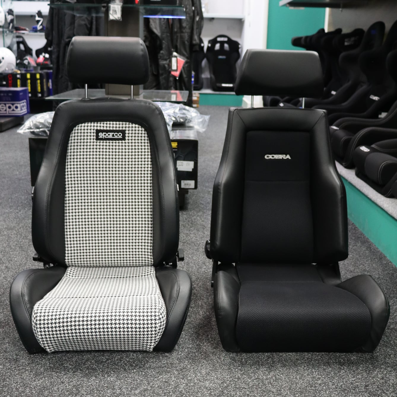 Sparco GT Houndstooth Edition and Cobra Le Mans reclining sport seats side by side from the front in the GSM Performance showroom
