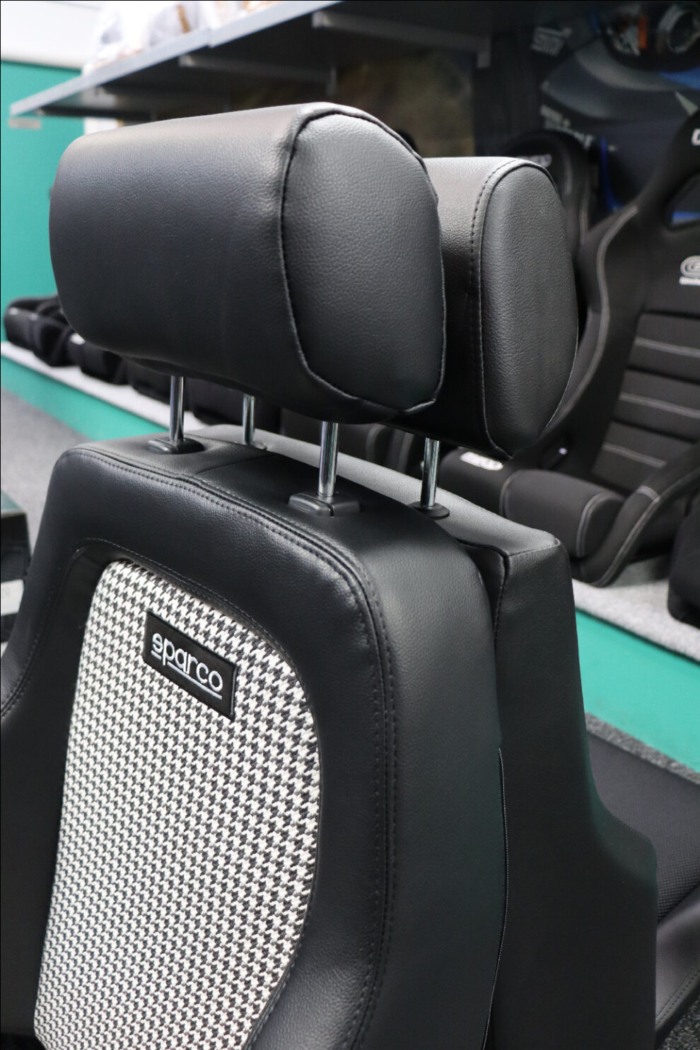 Close up of the Sparco GT Houndstooth headrest and upper backrest with the Cobra Le Mans headrest behind it