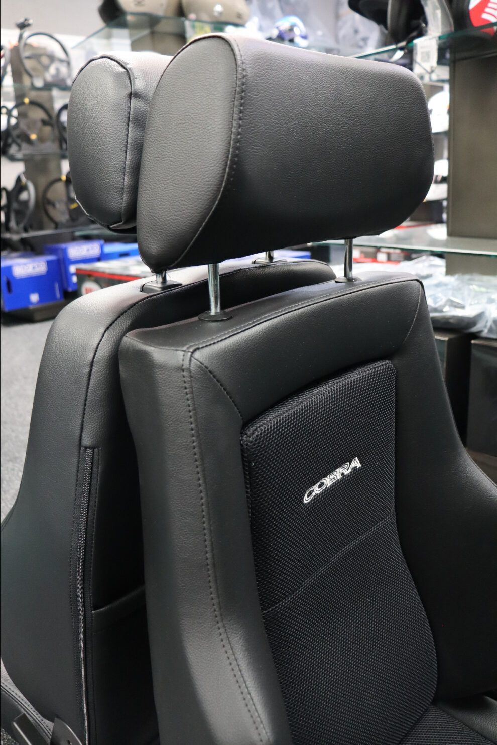 Close up of the Cobra Le Mans headrest and shoulder wings with the Sparco GT Houndstooth behind it