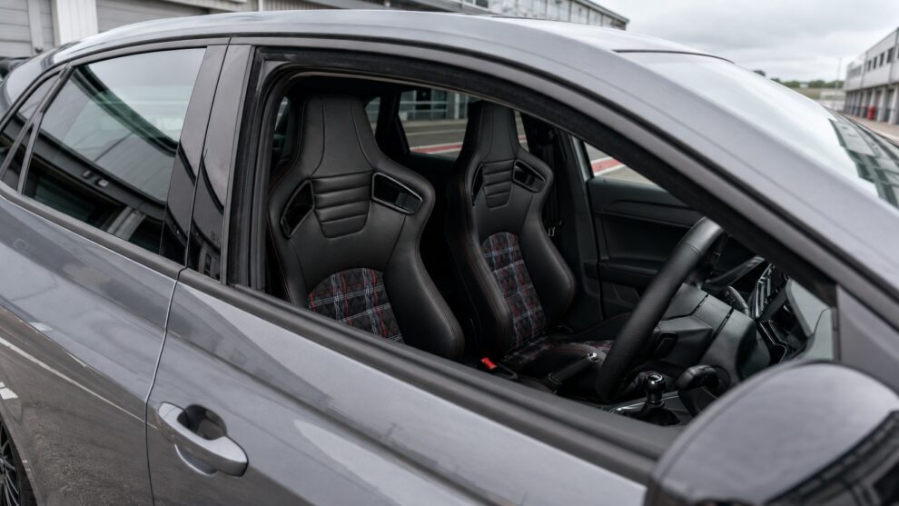 View through the right-hand driver's window of a Volkswagen Polo Mk6 showing Auto Style GT Red Tartan reclining seats