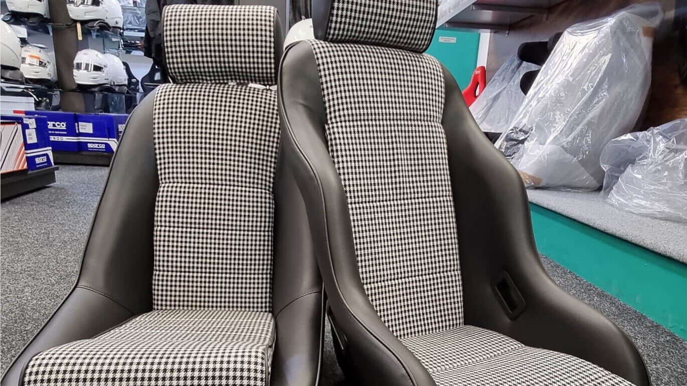 A pair of Cobra Classic RSR seats with black vinyl outers and black and white houndstooth centres in the GSM Performance showroom