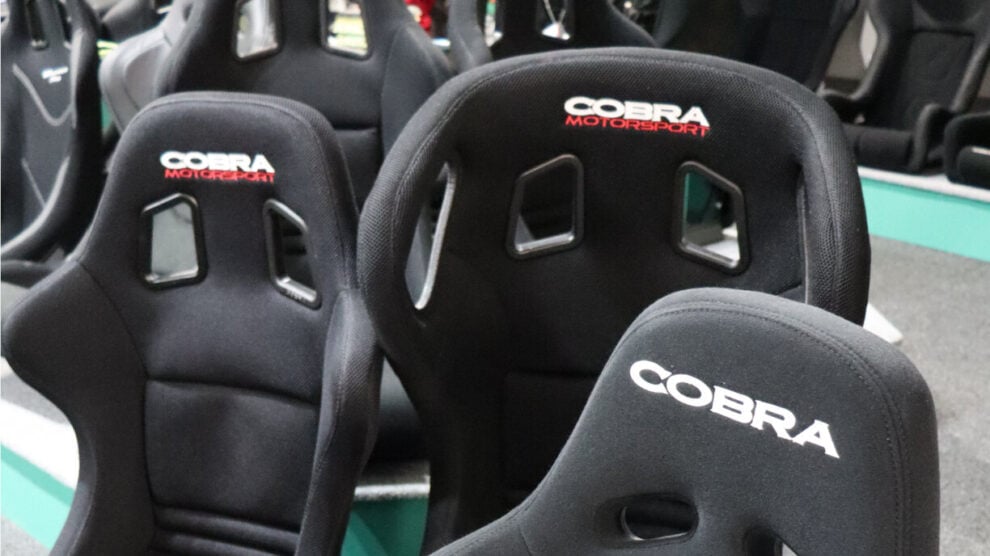 Rows of black Cobra fibreglass bucket seats on the showroom floor and display plinth
