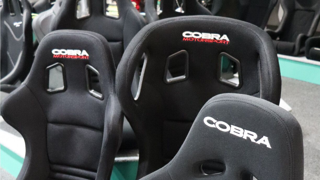 Rows of black Cobra fibreglass bucket seats on the showroom floor and display plinth