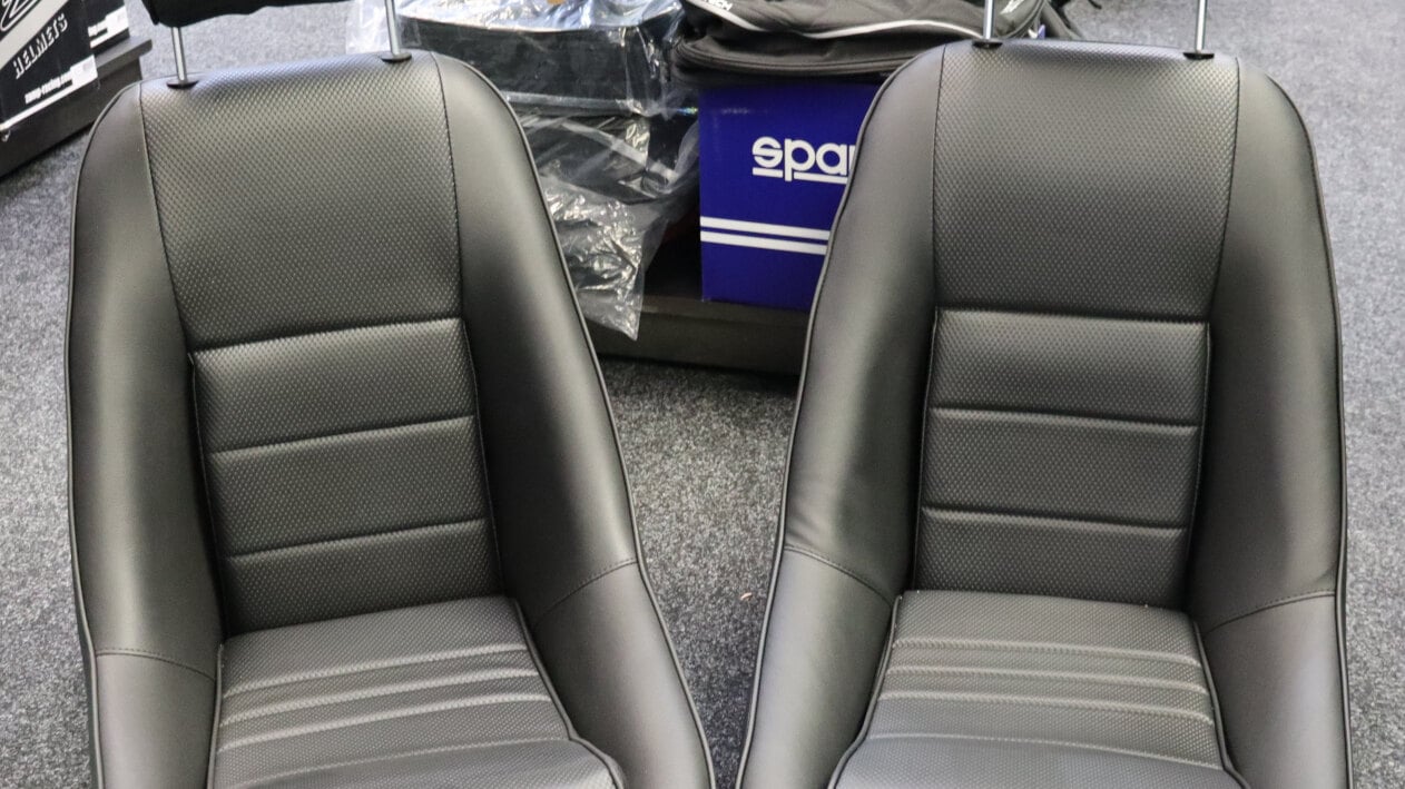 A pair of Cobra GT3 Historic seats in black vinyl with basketweave centres on the showroom floor