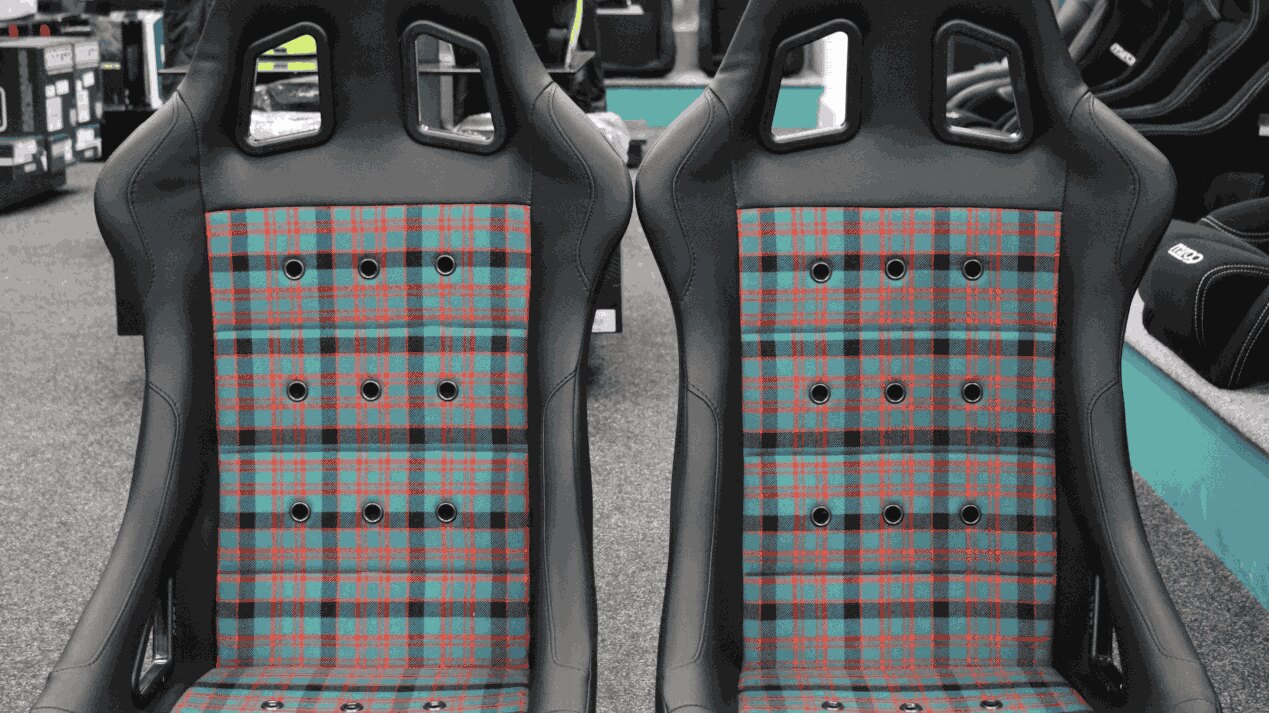 A pair of Cobra Monaco 40th Edition bucket seats with black vinyl and a customer supplied tartan centre in the GSM Performance showroom