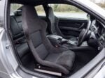 Pair of Cobra Nogaro Munich fixed back bucket seats in charcoal Alcantara fitted in the front of a right hand drive BMW E92 M3 coupe, seen from the open passenger door