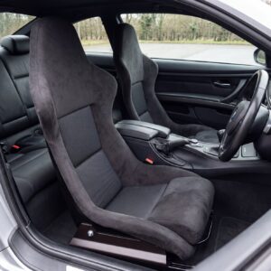 Pair of Cobra Nogaro Munich fixed back bucket seats in charcoal Alcantara fitted in the front of a right hand drive BMW E92 M3 coupe, seen from the open passenger door